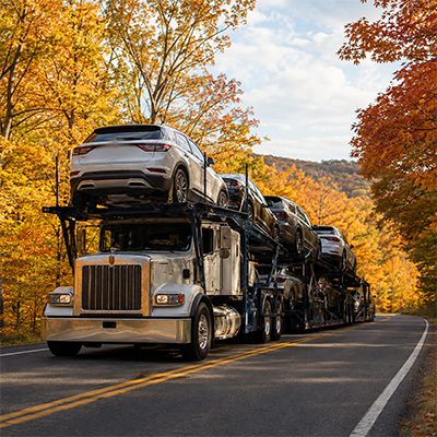 Car carrier under autumn foliage on a Kentucky highway