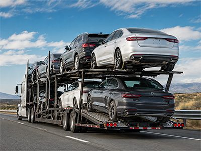 Sedans on an open carrier crossing the Nevada desert