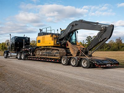 Excavator on a lowboy heavy-haul trailer